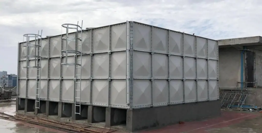 FRP sectional water tank installation at Olympia City, Cambodia – close view of completed rooftop tank with access ladders