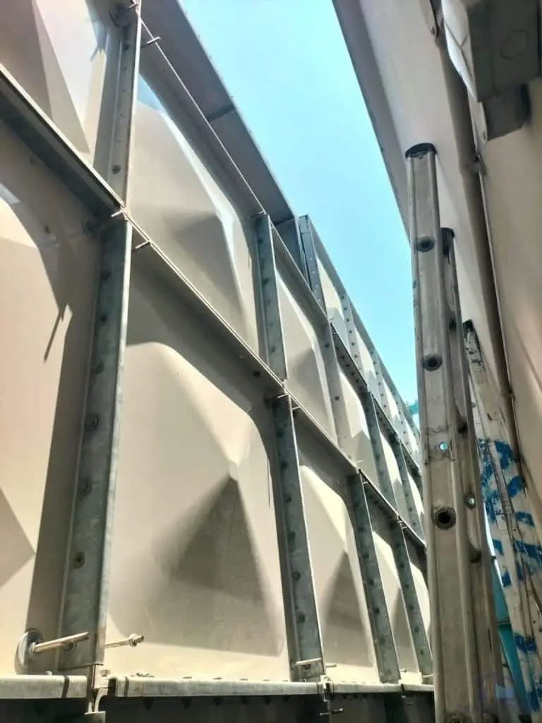 FRP water tank repair at Margaret Villa, Singapore – tank exterior within a narrow access area