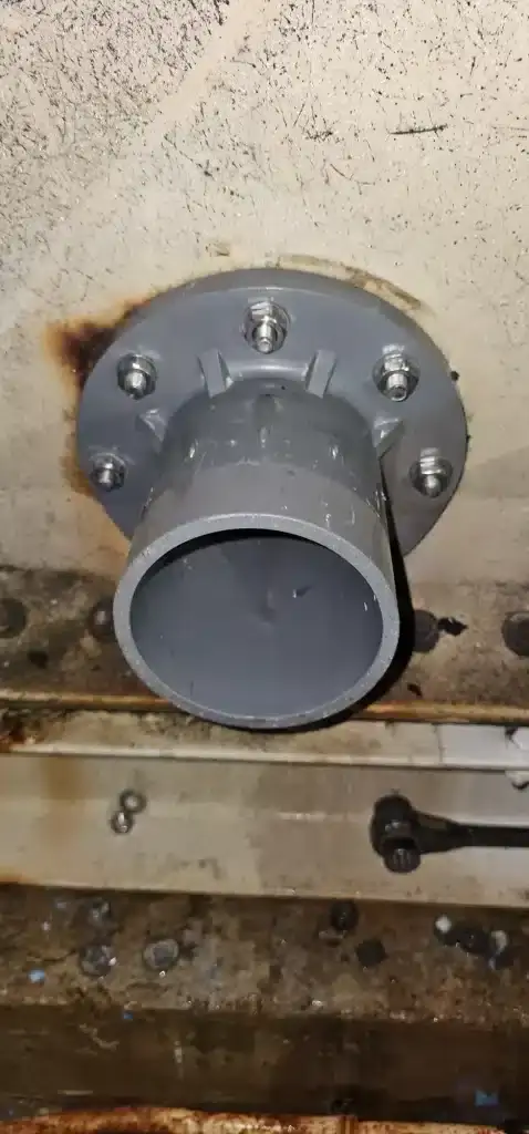FRP water tank repair at Quartz Industrial Building, Singapore – repaired tank outlet with new flange and pipe connection