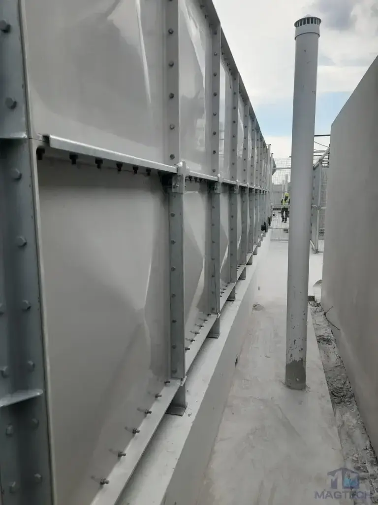FRP water tank installation at Jalan Tembusu, Singapore – narrow access space beside the completed sectional tank