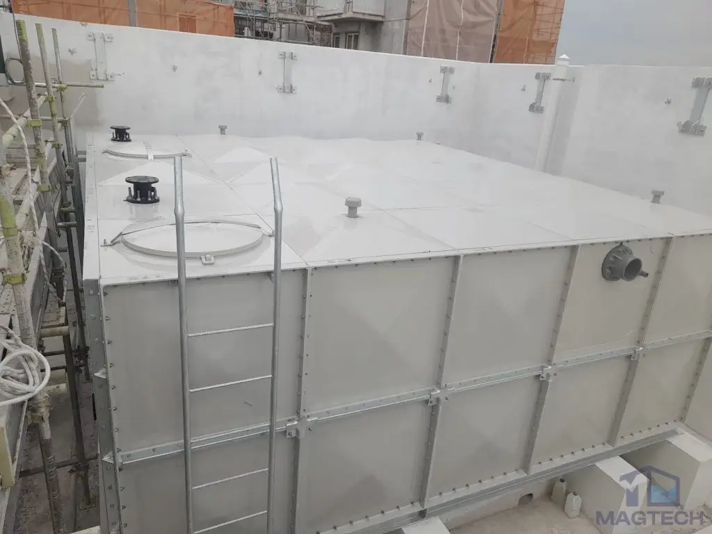 FRP water tank installation at Jalan Tembusu, Singapore – elevated view of the completed tank roof and access ladder
