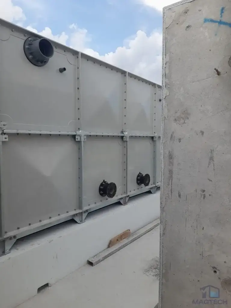 FRP water tank installation at Jalan Tembusu, Singapore – exterior panels with upper and lower pipe connections