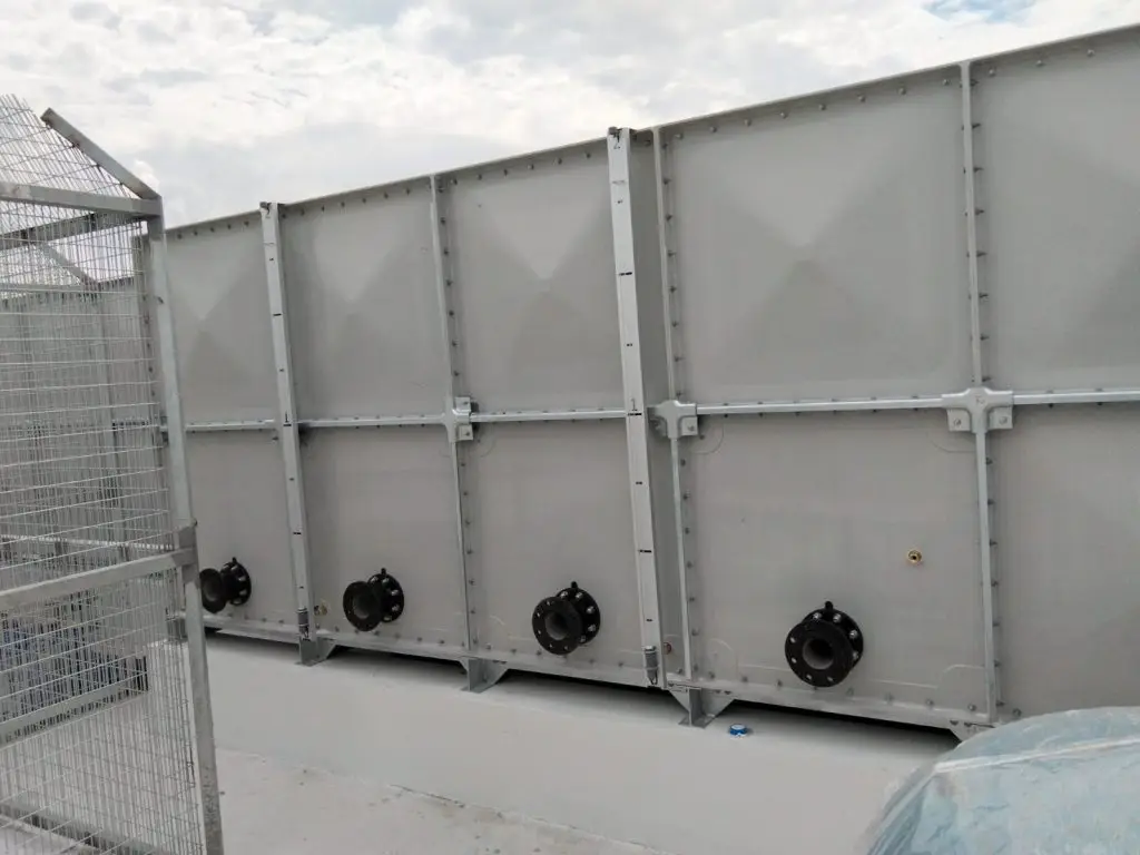 FRP water tank installation at Jalan Tembusu, Singapore – completed tank with multiple bottom pipe connections