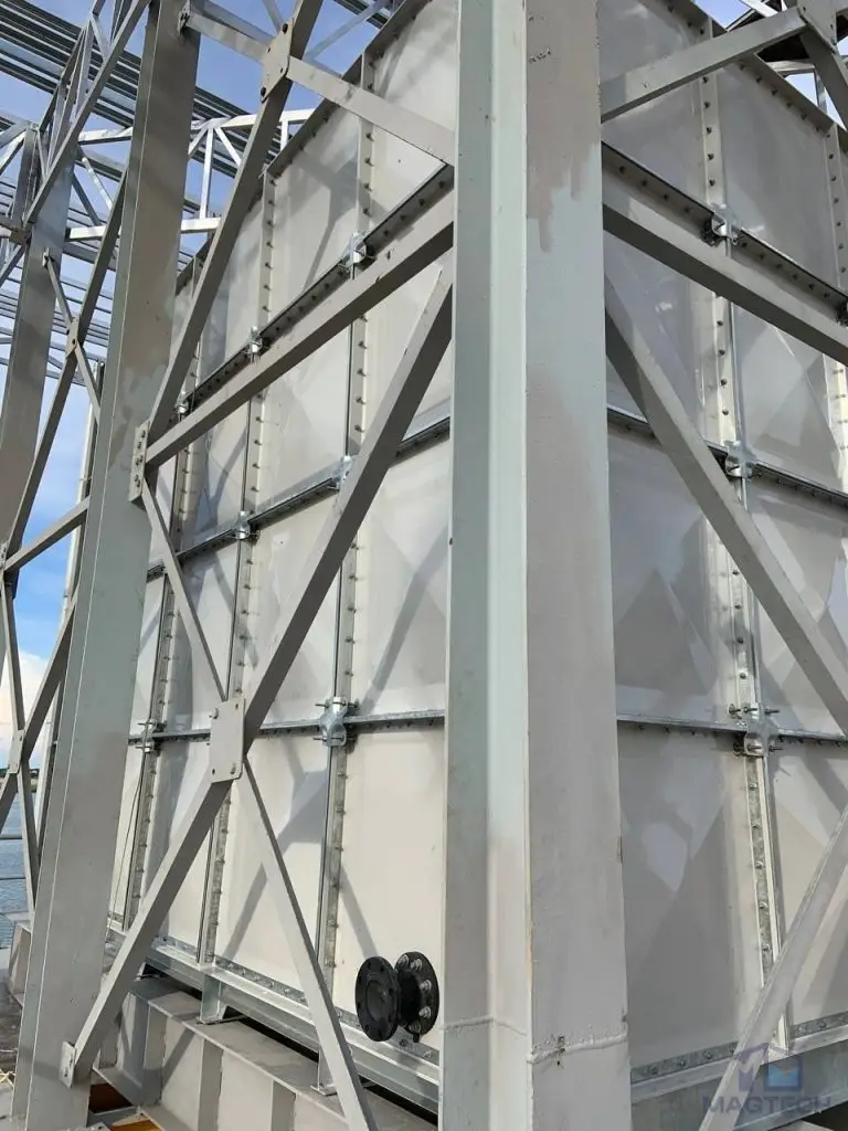 FRP/GRP water tank installation at Koh Norea Tower 1, Cambodia – completed tank panels with external steel bracing and pipe connection