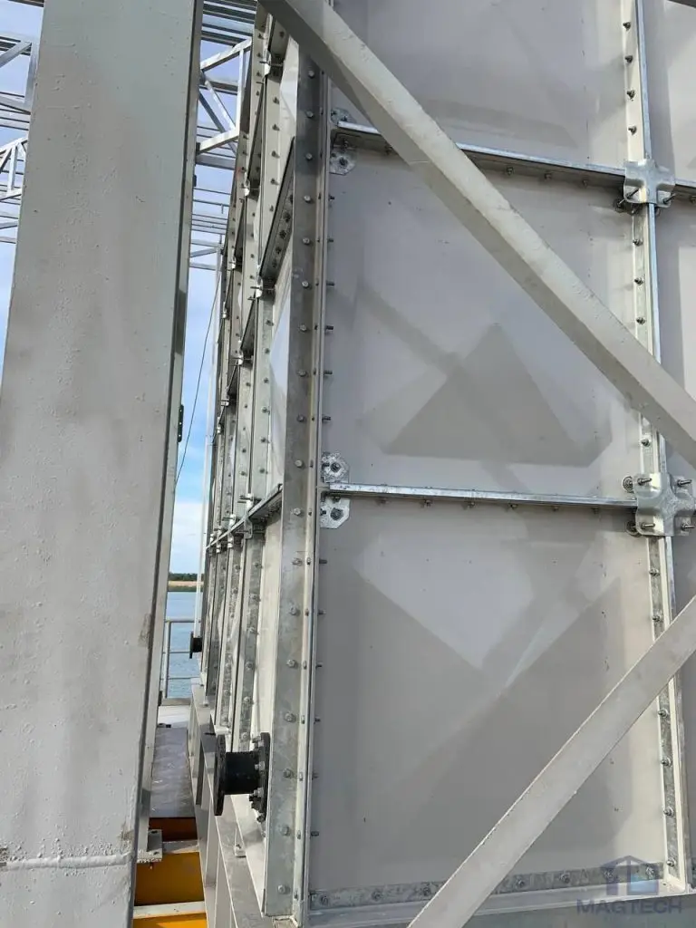 FRP/GRP water tank installation at Koh Norea Tower 1, Cambodia – close-up of sectional panels, external supports and pipe connection