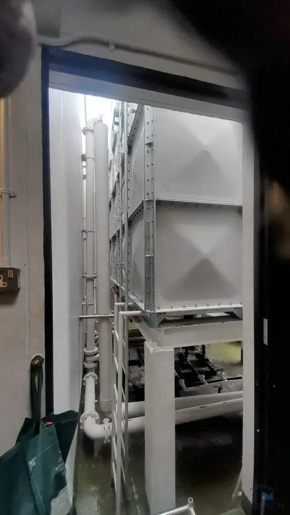 FRP water tank replacement at Parc Oasis Condominium, Singapore – completed sectional tank and pipework viewed from the plant room entrance