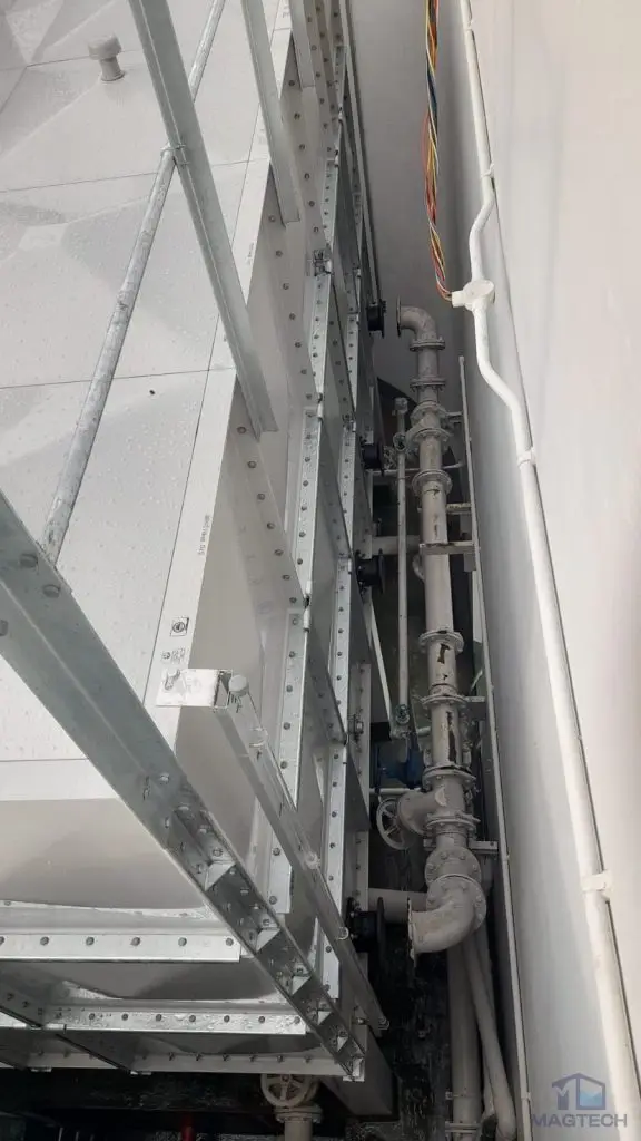 FRP water tank replacement at Parc Oasis Condominium, Singapore – pipework within the narrow space between the tanks