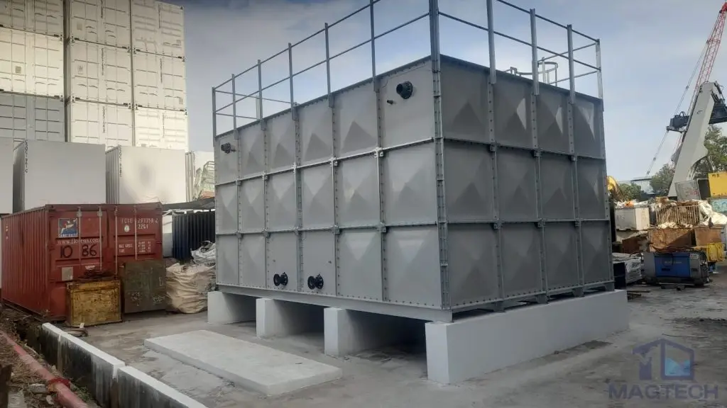 FRP water tank installation at 35 Pioneer Sector Dormitory, Singapore – side view of the completed tank on concrete supports with roof safety guardrails