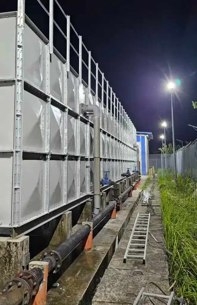 FRP water tank installation at Jurong Island, Singapore – side view of the completed sectional tank and pipework