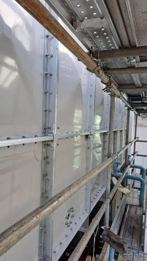 FRP/GRP domestic water tank replacement at One Finlayson Green, Singapore – completed exterior panels in the narrow service area