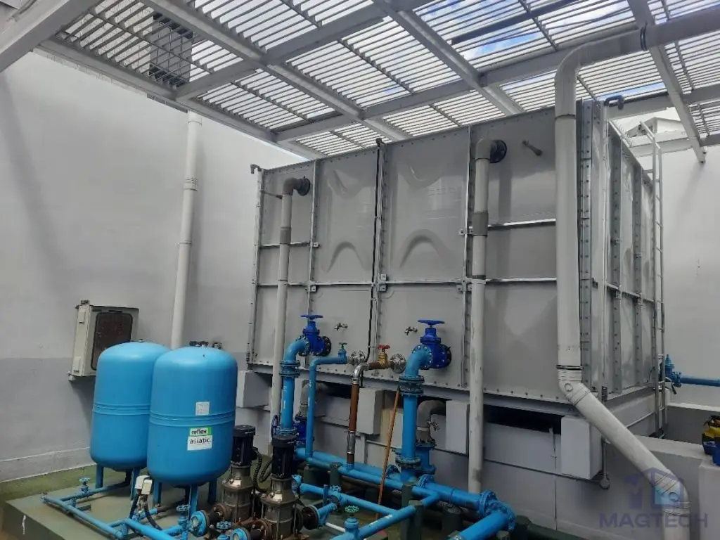 FRP/GRP domestic water tank replacement at Kim Tian Hotel, Singapore – completed sectional tank with booster pumps and connected pipework