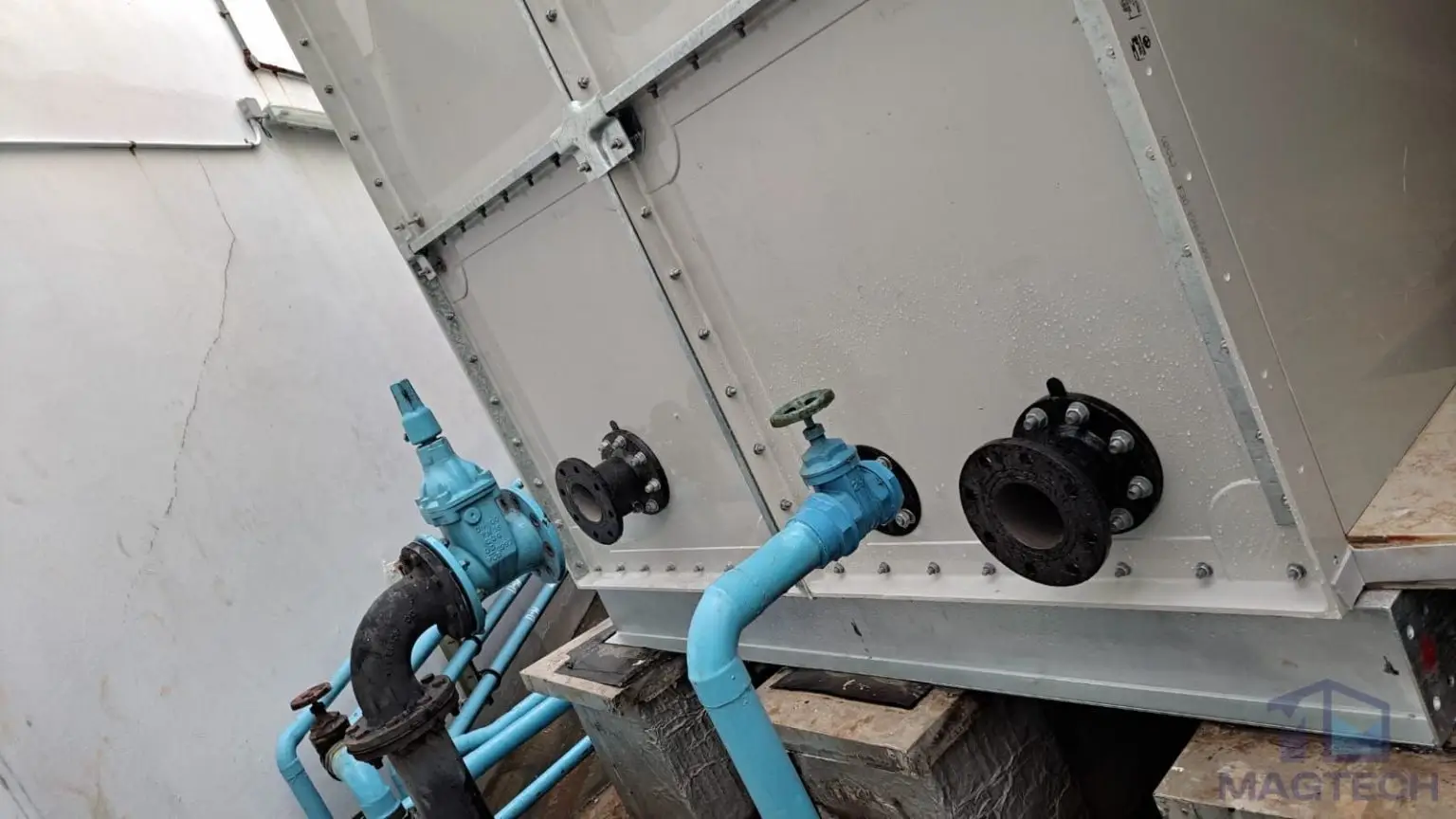 FRP/GRP water tank replacement at AIA Tower, Singapore – Flanged outlet and drain nozzles on the lower panels of an FRP water tank