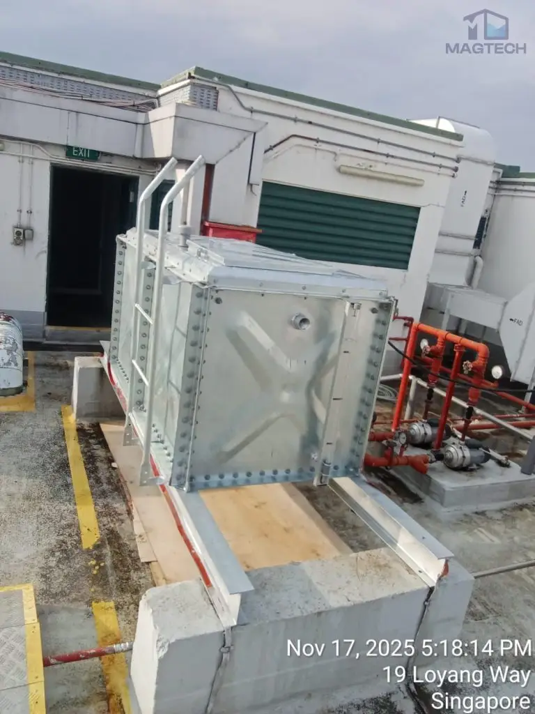 Water tank replacement at Changi Logistics Centre, Singapore – completed hose-reel water tank installed in a narrow service area