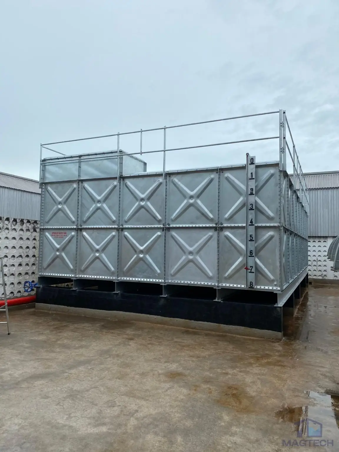 HDG pressed steel water tank installation at 188 Pandan Loop, Singapore – front view of the completed sectional tank with roof safety guardrails
