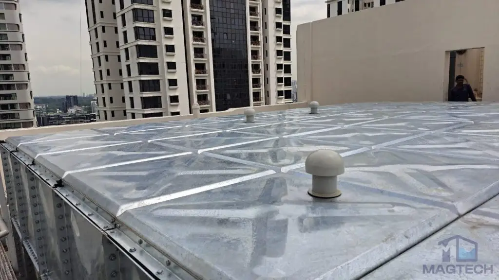 HDG pressed steel water tank replacement at Heritage Apartment, Singapore – rooftop view of the completed tank with ventilation outlets