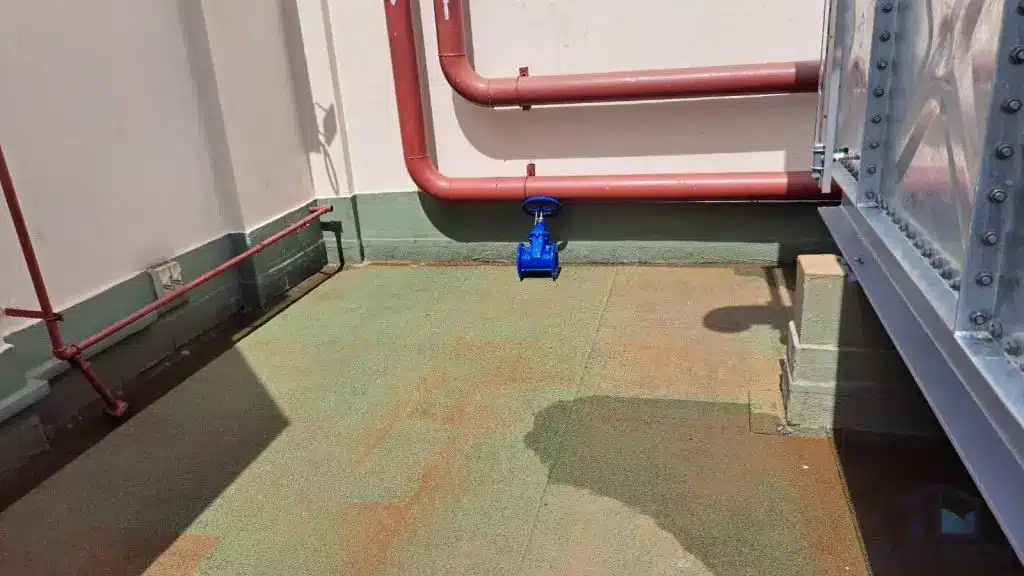 HDG pressed steel water tank replacement at Heritage Apartment, Singapore – connected pipework and blue isolation valve beside the tank