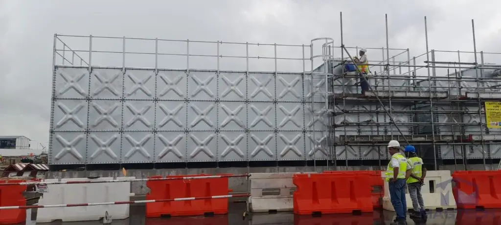 Hot-dipped galvanized pressed steel water tanks at ARC Changi T5, Singapore – front view of HDG tank during installation