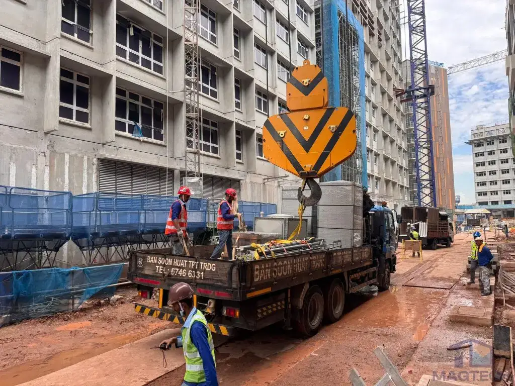 FRP water tank installation at Tengah HDB, Singapore – tank materials being lifted by crane at the construction site