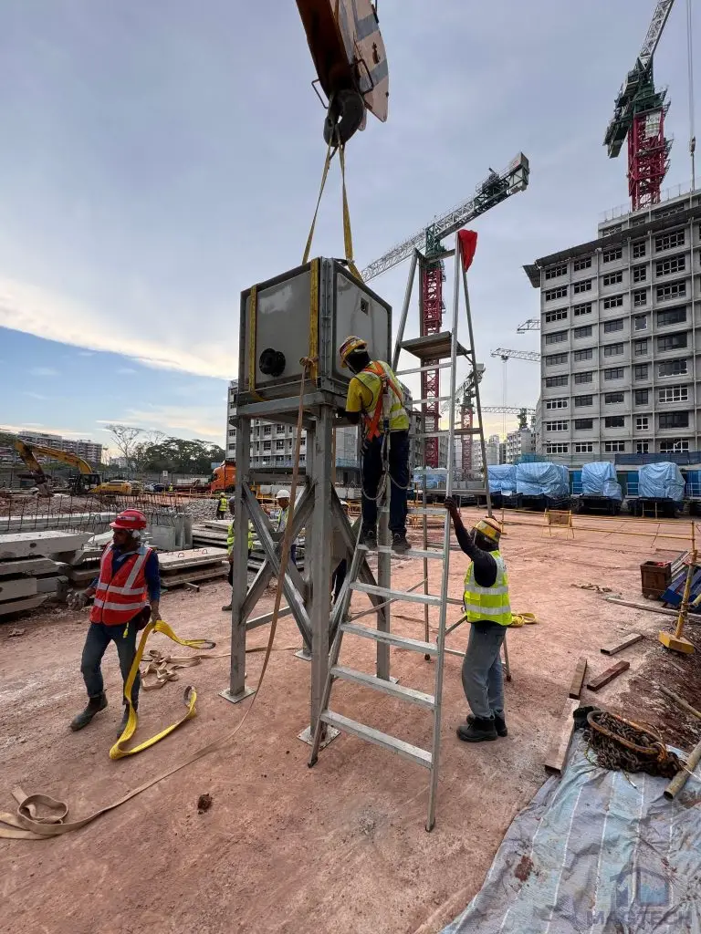 FRP water tank installation at Tengah HDB, Singapore – elevated tank being lifted into position by crane