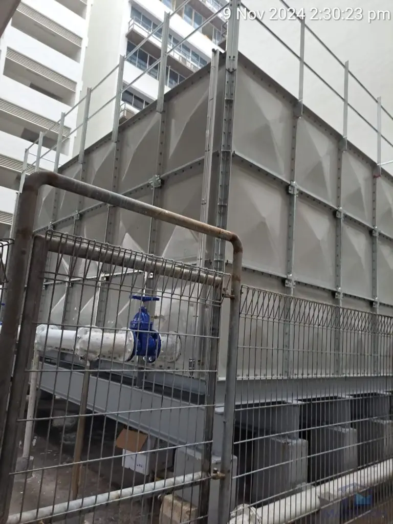 Tower A FRP Water Tank Replacement at Northlink Building, Singapore – completed tank with connected pipework and surrounding safety fencing