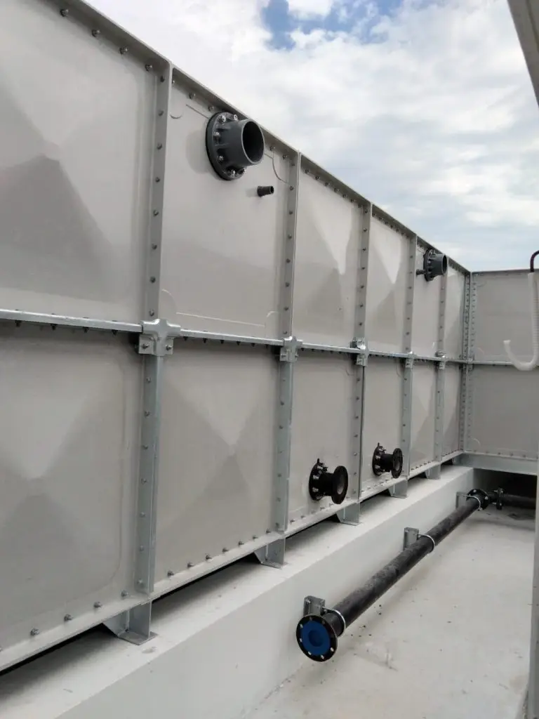 FRP water tank installation at Jalan Tembusu, Singapore – exterior tank panels with connected pipework and valves