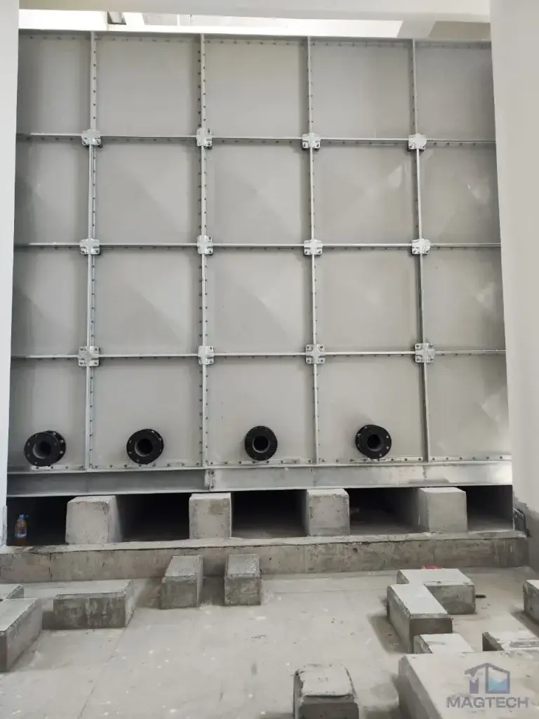 FRP/GRP water tank installation at Norodom Business Centre, Cambodia – exterior tank panels with bottom pipe connections