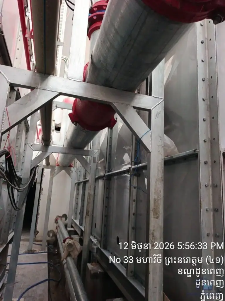 FRP/GRP water tank installation at Norodom Business Centre, Cambodia – pipe connections within the narrow tank access area