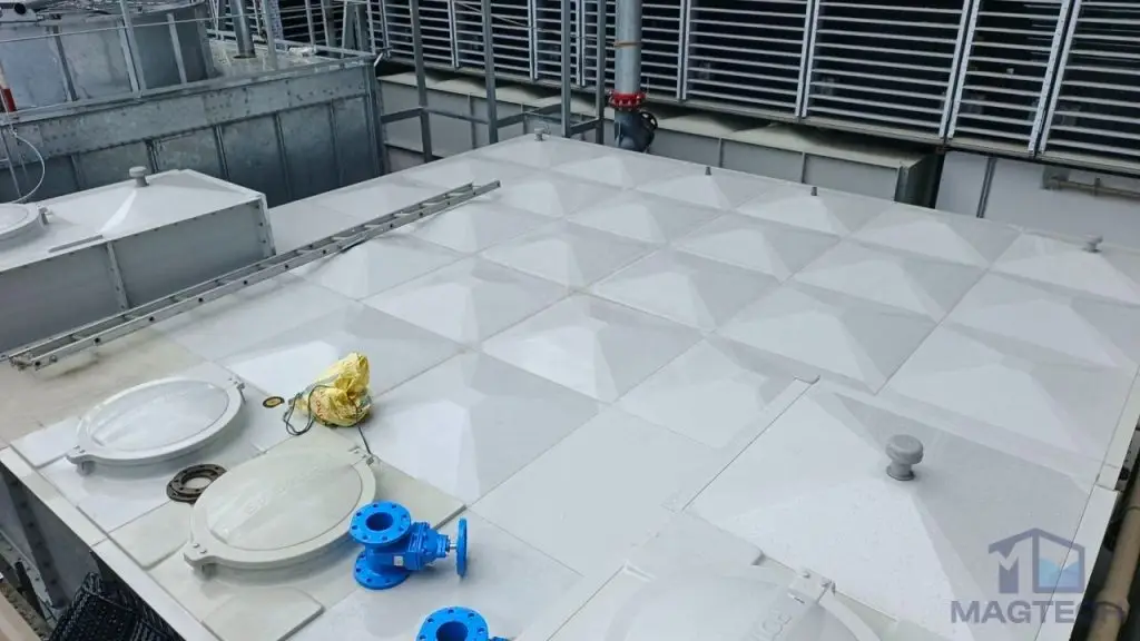 FRP/GRP water tank installation at Norodom Business Centre, Cambodia – completed roof panels, access hatches and blue valves
