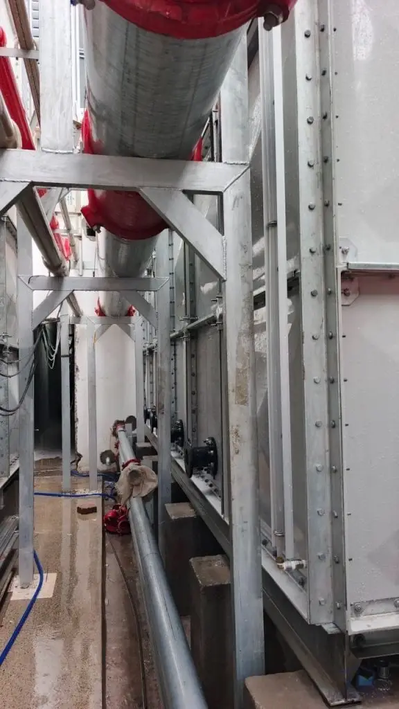 FRP/GRP water tank installation at Norodom Business Centre, Cambodia – pipe connections and steel supports beside the tank