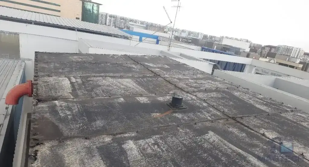 Water tank cover replacement and structural roof support renewal at AMA Building, Singapore – deteriorated existing tank cover before replacement