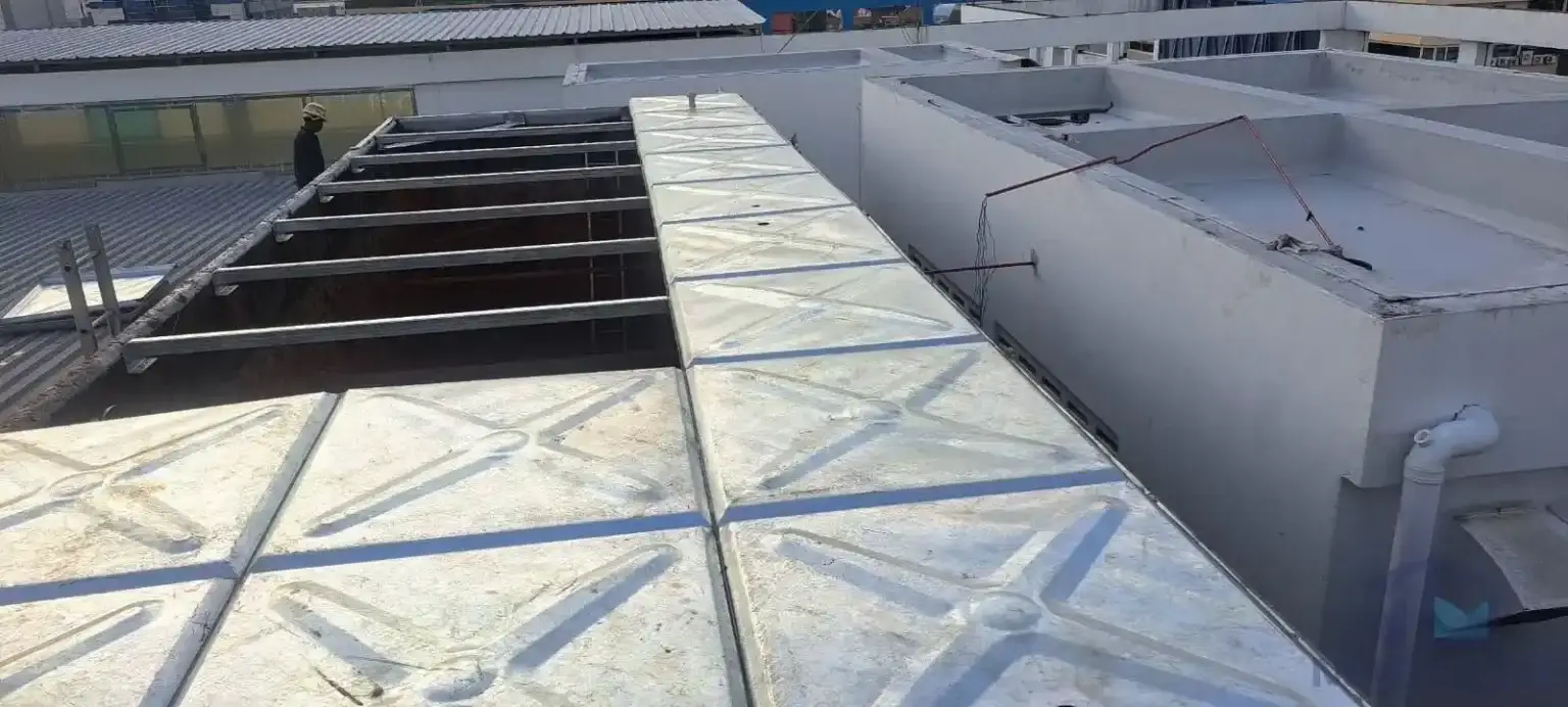 Water tank cover replacement and structural roof support renewal at AMA Building, Singapore – new cover panels installed over renewed steel supports