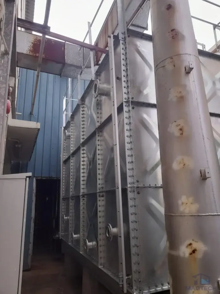 HDG pressed steel water tank installation at 71 Tuas View Loop, Singapore – side view of the completed tank in a narrow access area
