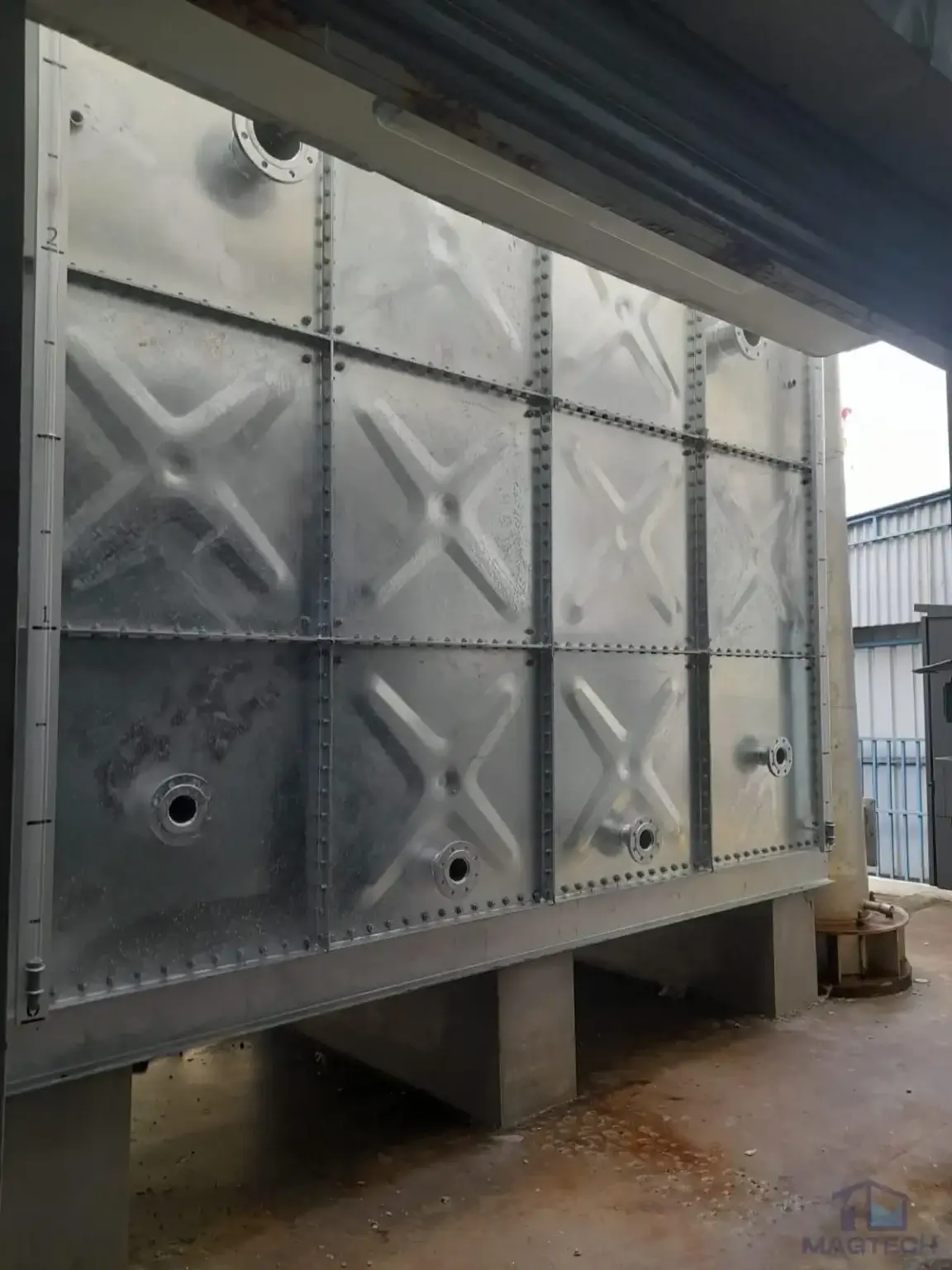 HDG pressed steel water tank installation at 71 Tuas View Loop, Singapore – front view of the completed sectional tank and pipe connections