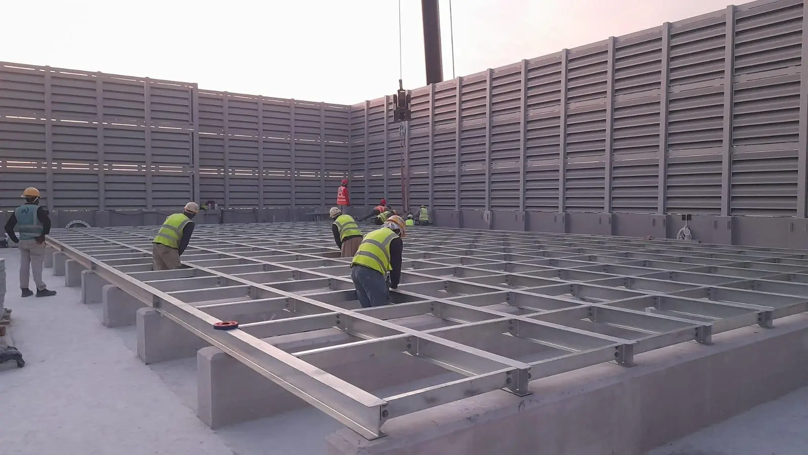 A group of workers are diligently working on installing or replacing a water tank Featured image - water tank replacement cost Singapore