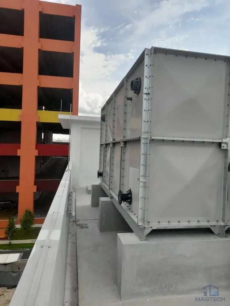 FRP/GRP water tank installation at 24A Senoko Road, Singapore – side view of the completed tank and concrete supports