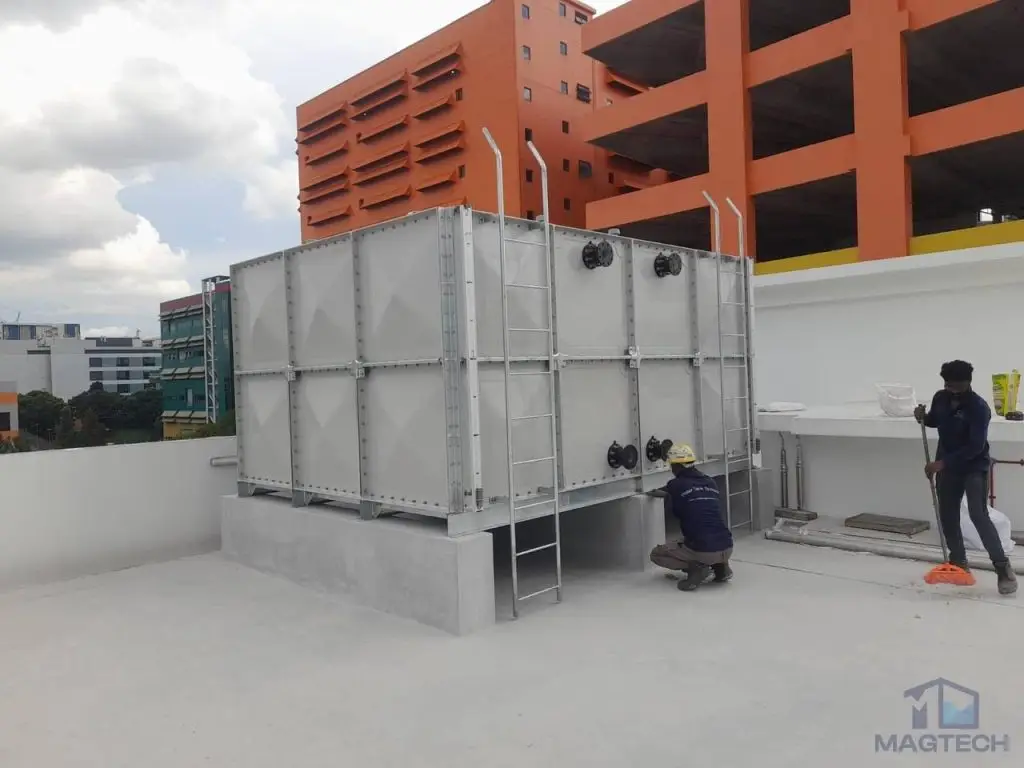 FRP/GRP water tank installation at 24A Senoko Road, Singapore – completed tank with workers carrying out final site work