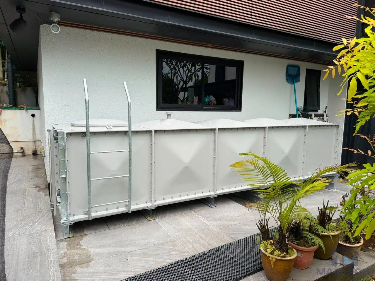FRP rainwater tank installation at 36 Fifth Avenue Singapore - completed tank along the house