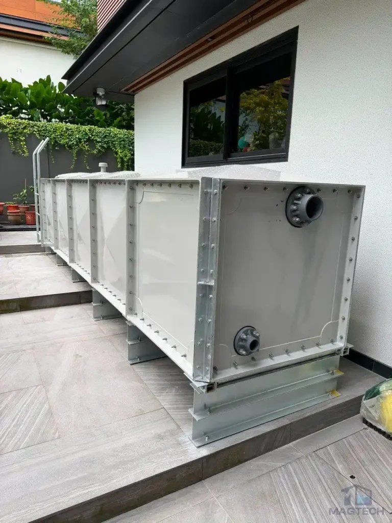 FRP rainwater tank installation at 36 Fifth Avenue Singapore - skid base stepping across the uneven terrace