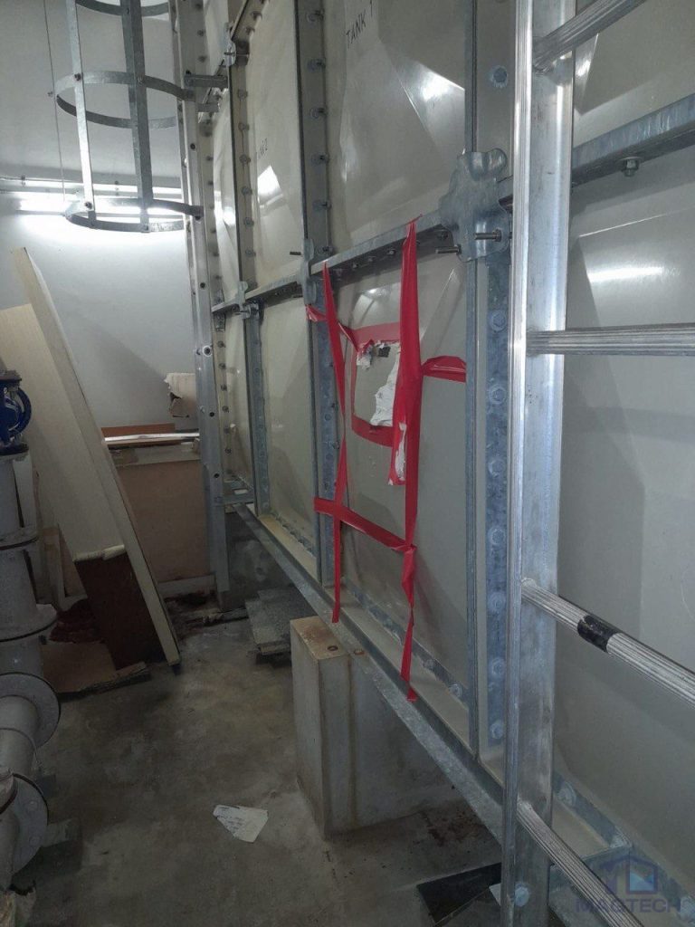 FRP water tank panel repair at 8 Novena Drive Singapore - cracked panel marked before removal