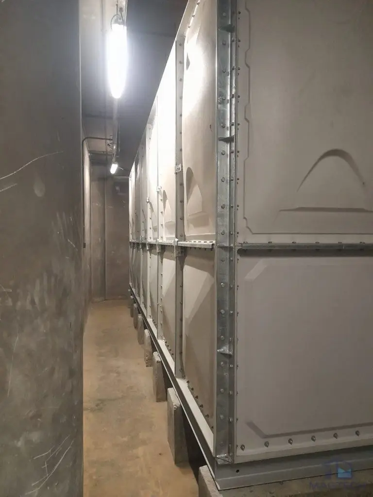 Insulated FRP water tank replacement at Resorts World Sentosa, Singapore - close-up of panel edges and bolted steel supports