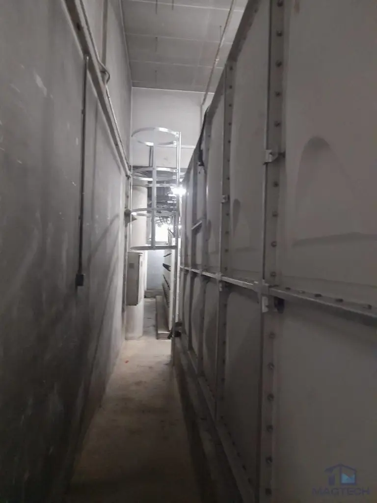 Insulated FRP water tank replacement at Resorts World Sentosa, Singapore - narrow plant room access beside the tank