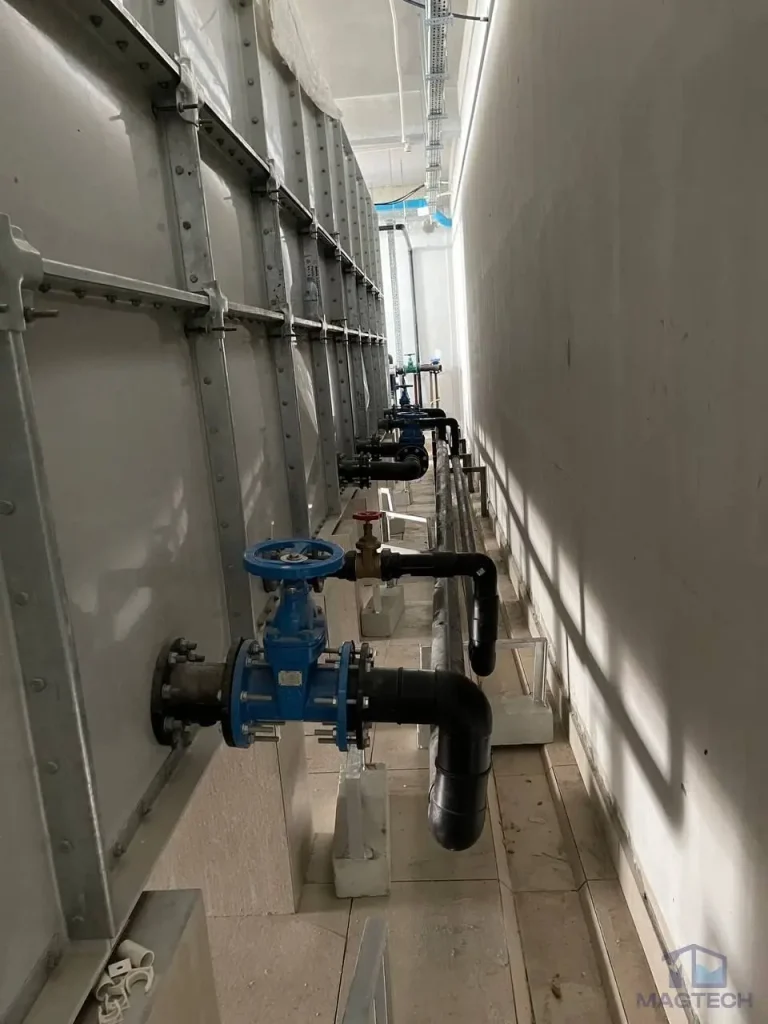 GRP water tank installation at Grand Villa Cambodia - outlet valves along the access corridor